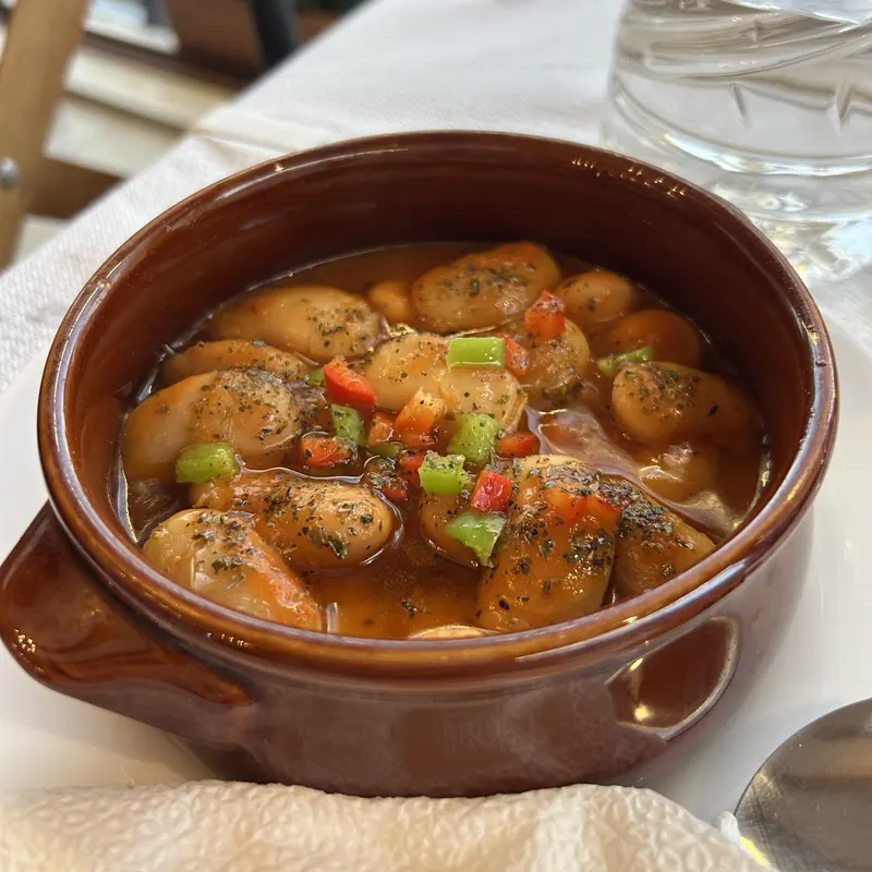 Beans with peppers in a clay pot